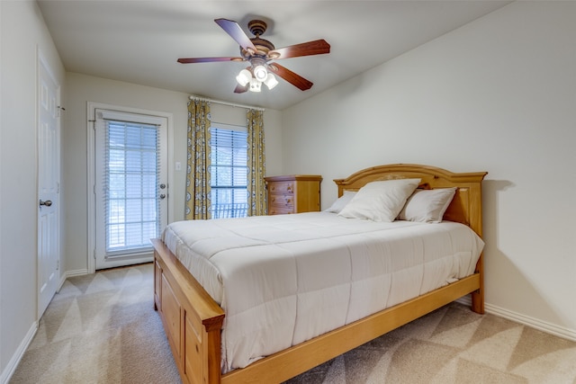 bedroom with ceiling fan, light colored carpet, and access to outside