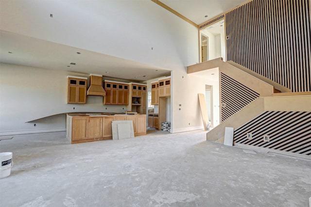 unfurnished living room with a towering ceiling