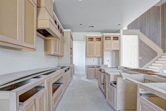 kitchen featuring light brown cabinets and premium range hood