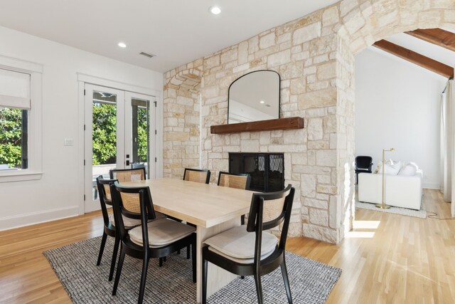 kitchen featuring stainless steel built in refrigerator, a kitchen island with sink, custom range hood, and white cabinets