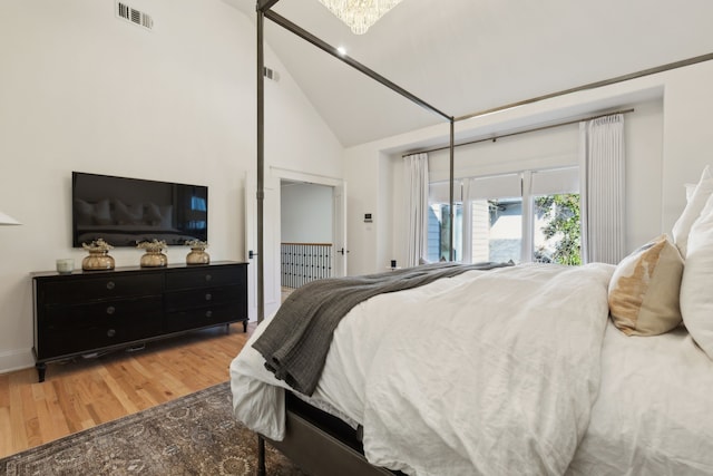 bedroom with lofted ceiling and hardwood / wood-style floors