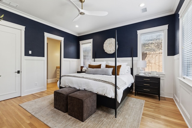 bedroom featuring crown molding, ceiling fan, and light wood-type flooring