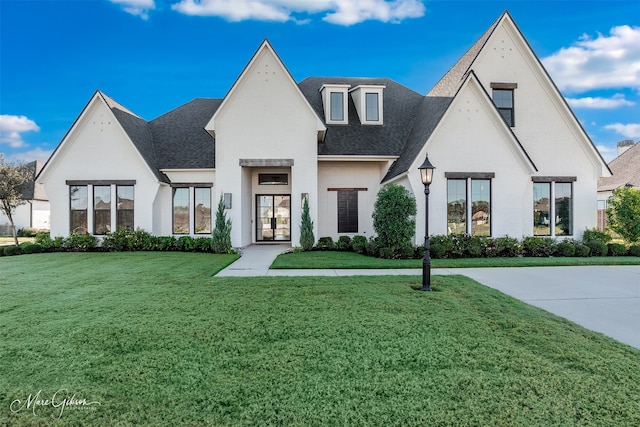 view of front of property with a front yard and french doors