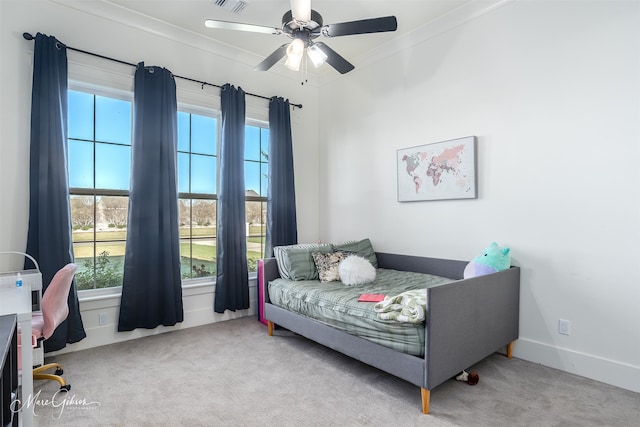 bedroom with ceiling fan, light colored carpet, ornamental molding, and multiple windows