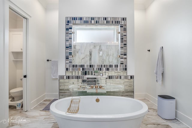 bathroom featuring a bath and toilet