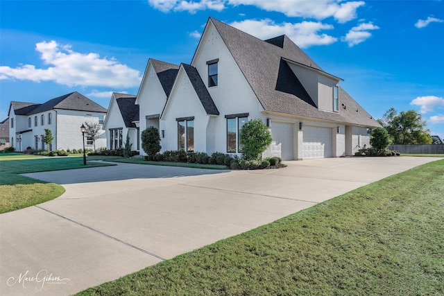 view of front of house featuring a garage and a front lawn