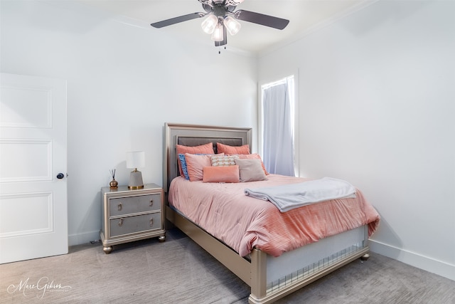 carpeted bedroom with ceiling fan and ornamental molding