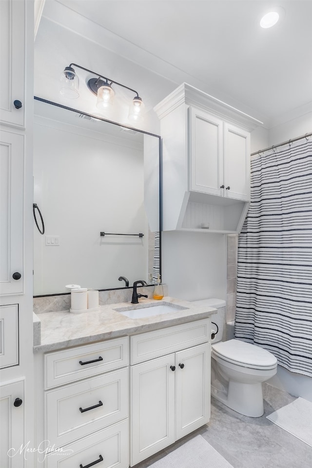 bathroom featuring vanity, toilet, and walk in shower