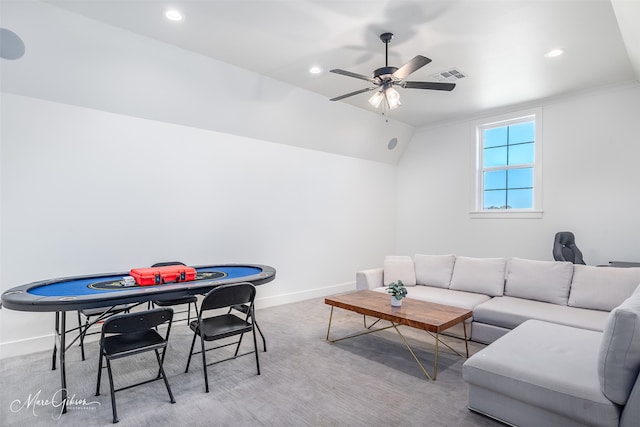 carpeted living room with ceiling fan and lofted ceiling