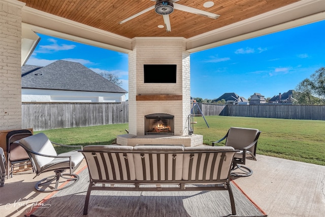 view of patio featuring an outdoor living space with a fireplace and ceiling fan