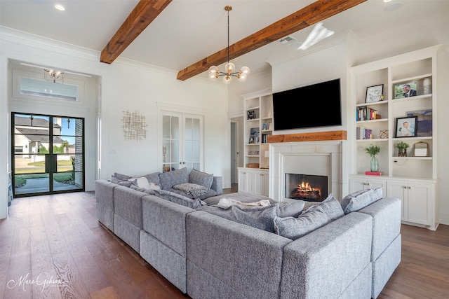 living room with beam ceiling, ornamental molding, dark wood-type flooring, and a notable chandelier