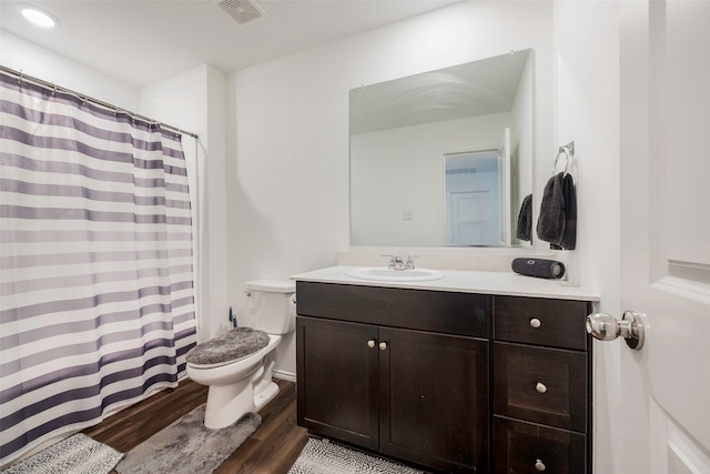 bathroom featuring vanity, toilet, and wood-type flooring