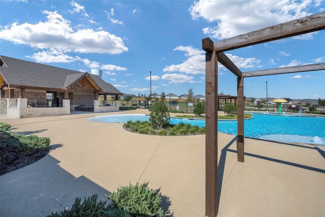 view of pool featuring an outdoor kitchen and a patio