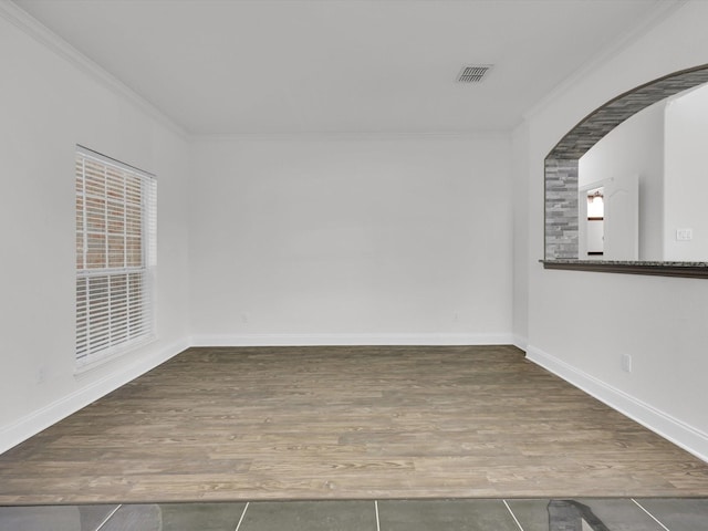 tiled spare room with ornamental molding