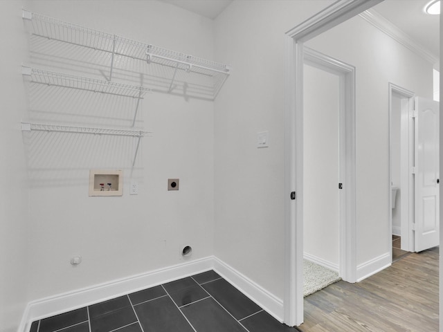 laundry room with hookup for a washing machine, ornamental molding, dark tile patterned floors, gas dryer hookup, and electric dryer hookup