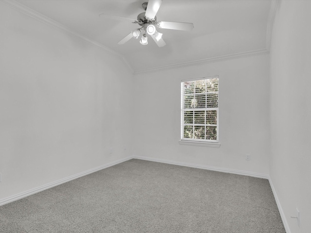 carpeted empty room featuring ceiling fan, crown molding, and lofted ceiling