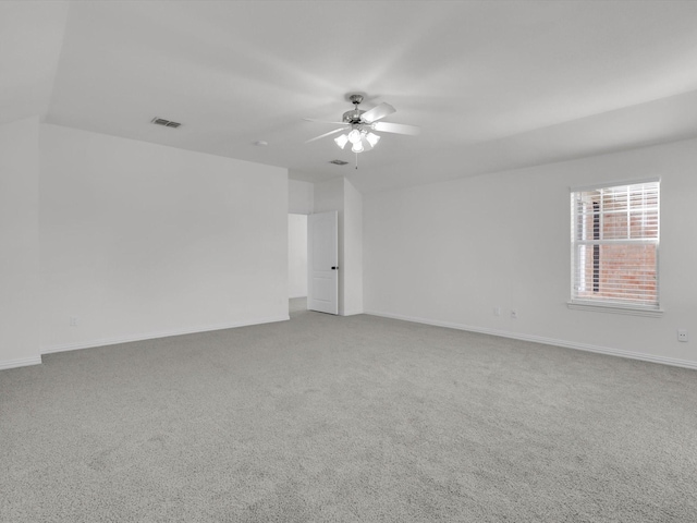 carpeted spare room with ceiling fan