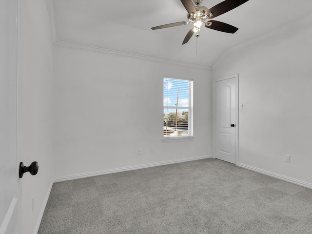 empty room featuring ceiling fan, light colored carpet, lofted ceiling, and ornamental molding