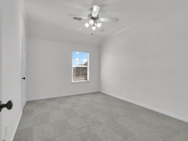 spare room featuring ceiling fan, light colored carpet, and ornamental molding