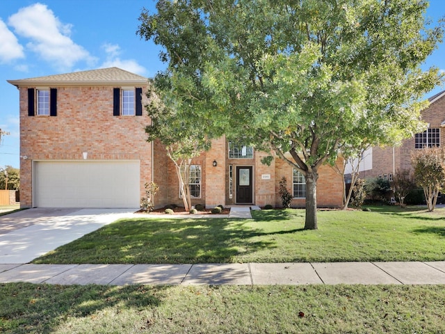 view of front of house with a front yard and a garage