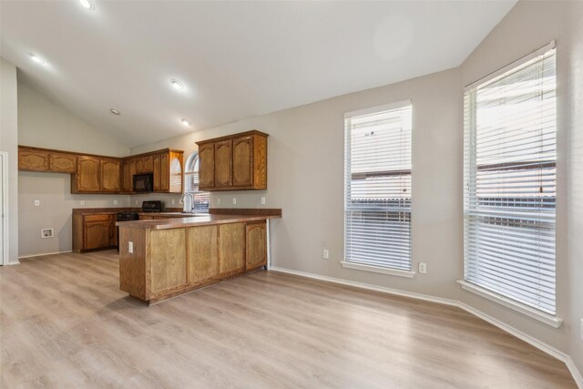 unfurnished living room featuring high vaulted ceiling, light hardwood / wood-style flooring, and ceiling fan