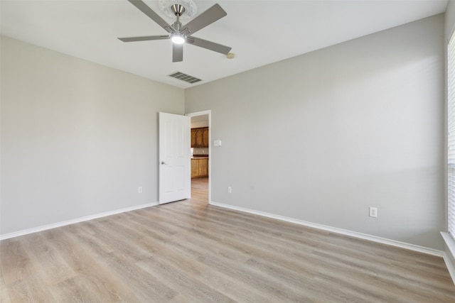 spare room with light hardwood / wood-style floors, ceiling fan, and a healthy amount of sunlight