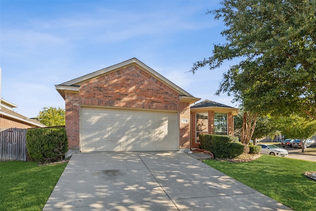 view of front of house with a garage and a front yard