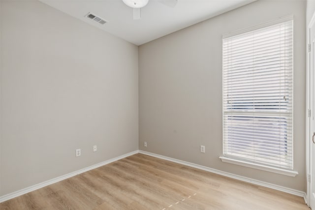 spare room with ceiling fan, a healthy amount of sunlight, and light hardwood / wood-style flooring