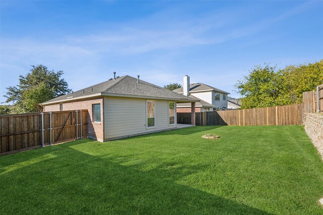 rear view of property featuring a yard