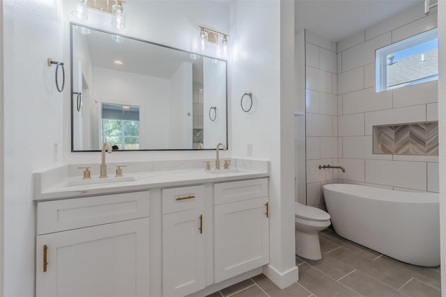 bathroom featuring a tub to relax in, plenty of natural light, tile walls, and toilet