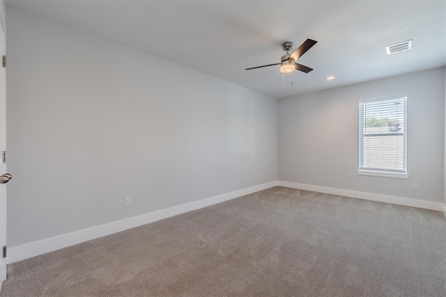 carpeted spare room featuring ceiling fan