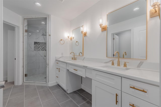 bathroom featuring tile patterned floors, a shower with door, and vanity