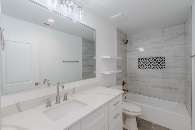 full bathroom with tile patterned flooring, vanity, toilet, and tiled shower / bath