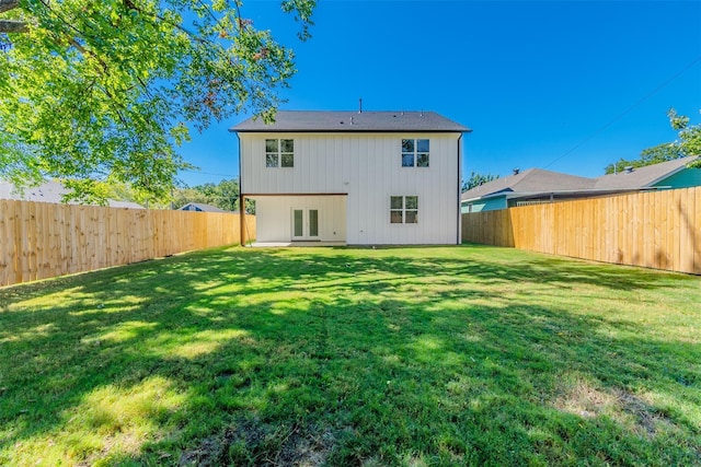 rear view of house with a yard