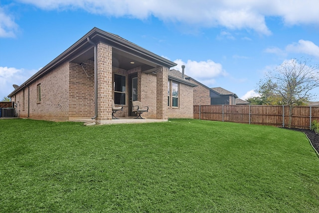 back of property featuring a patio area, a yard, and central AC