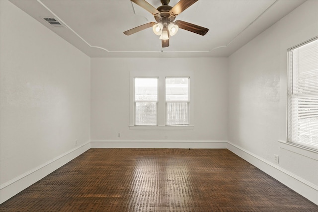 unfurnished room featuring ceiling fan, plenty of natural light, and dark hardwood / wood-style floors