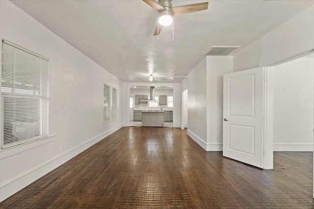 unfurnished living room featuring visible vents, ceiling fan, and baseboards