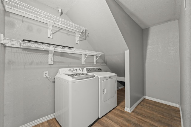 washroom featuring dark wood-type flooring and washing machine and clothes dryer