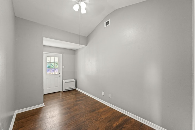 spare room with ceiling fan, dark hardwood / wood-style flooring, and lofted ceiling