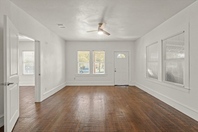 foyer entrance featuring visible vents, ceiling fan, and baseboards