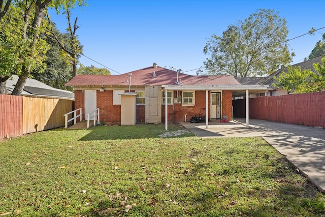 rear view of house featuring a patio area and a yard