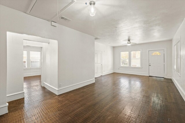 spare room with ceiling fan and dark hardwood / wood-style flooring