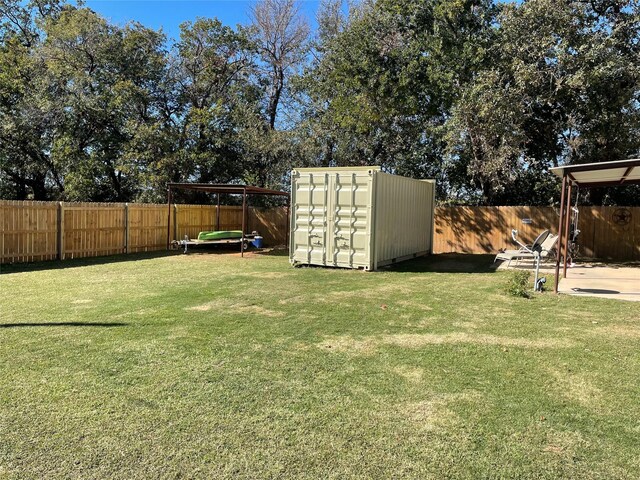 view of yard featuring a shed and a trampoline