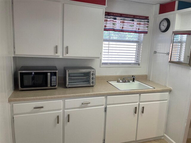 kitchen with white cabinets and sink