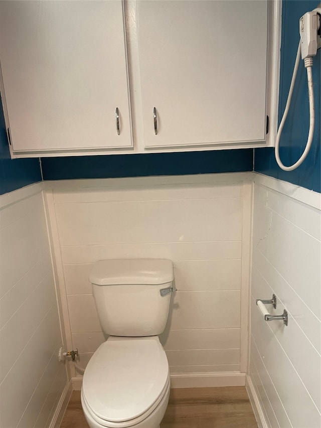 bathroom featuring wood-type flooring and toilet