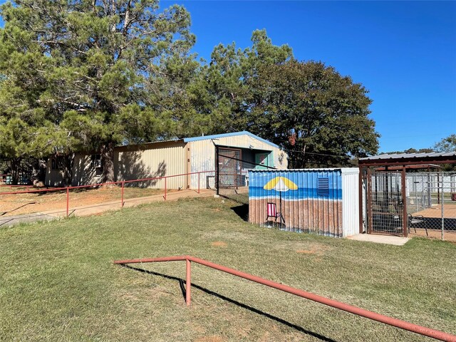 view of community with an outbuilding and a lawn