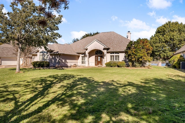 view of front of house with a front yard and central AC unit