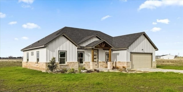 modern farmhouse with a front yard and a garage