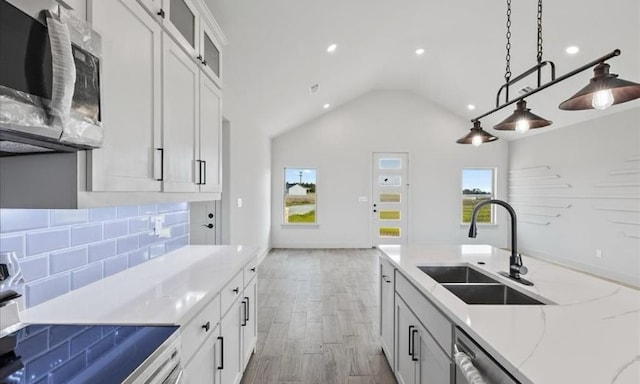 kitchen with stainless steel appliances, white cabinetry, a wealth of natural light, and sink