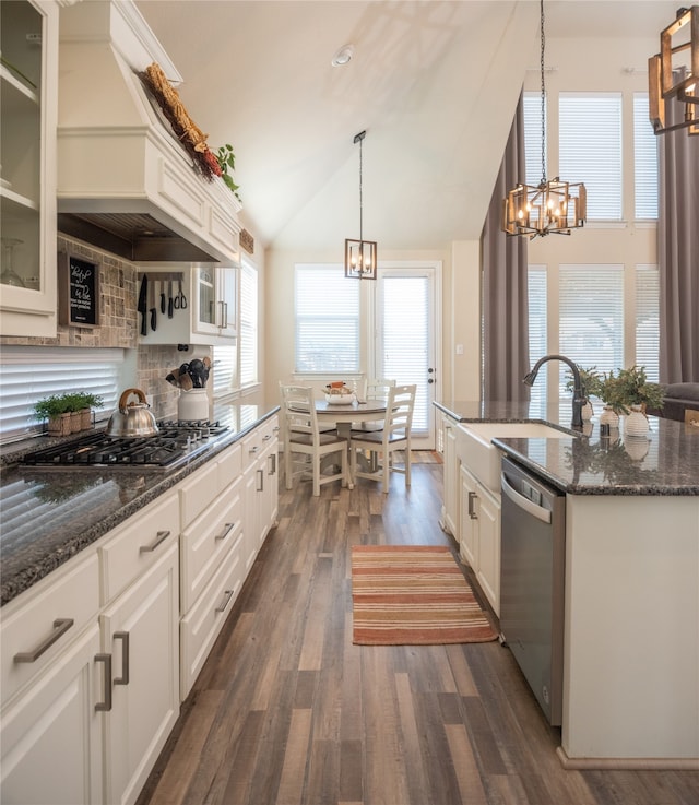 kitchen with lofted ceiling, dark wood-type flooring, white cabinets, sink, and stainless steel appliances